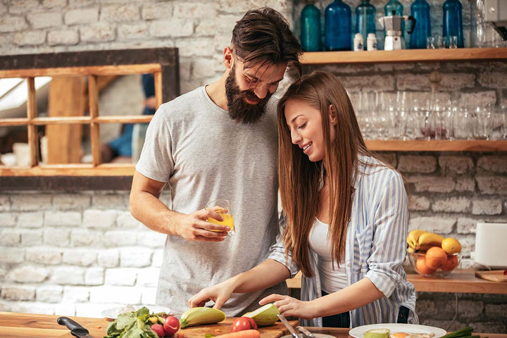 man and woman couple enjoying time together in kitchen